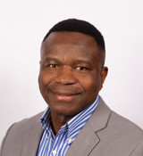 A close-up of a man smiling.