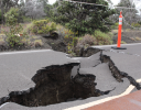 A road with a pile of dirt on the side.